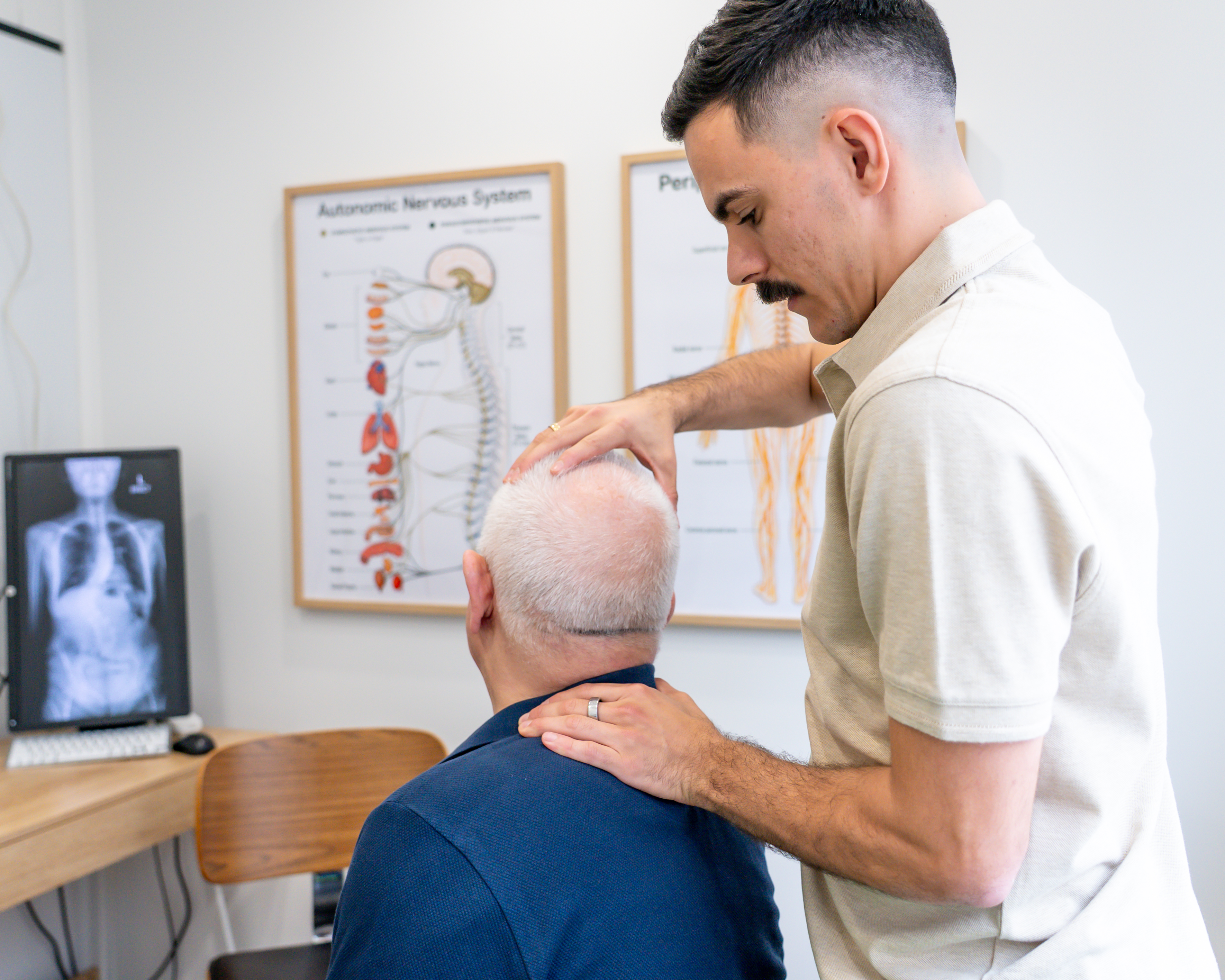 Alma Health chiropractor assessing a patient during a consultation