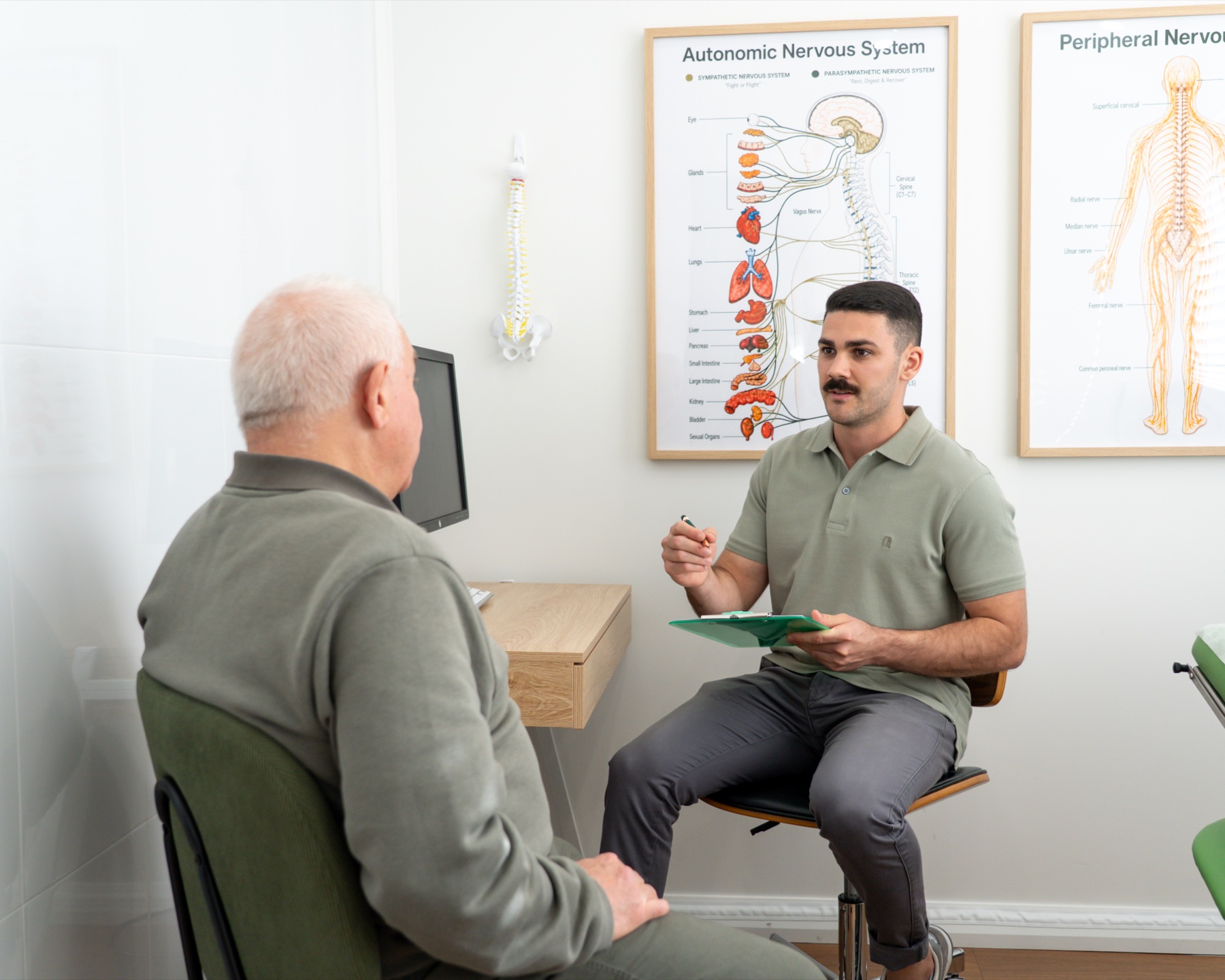 Alma Health chiropractor listening to a patient during a consultation