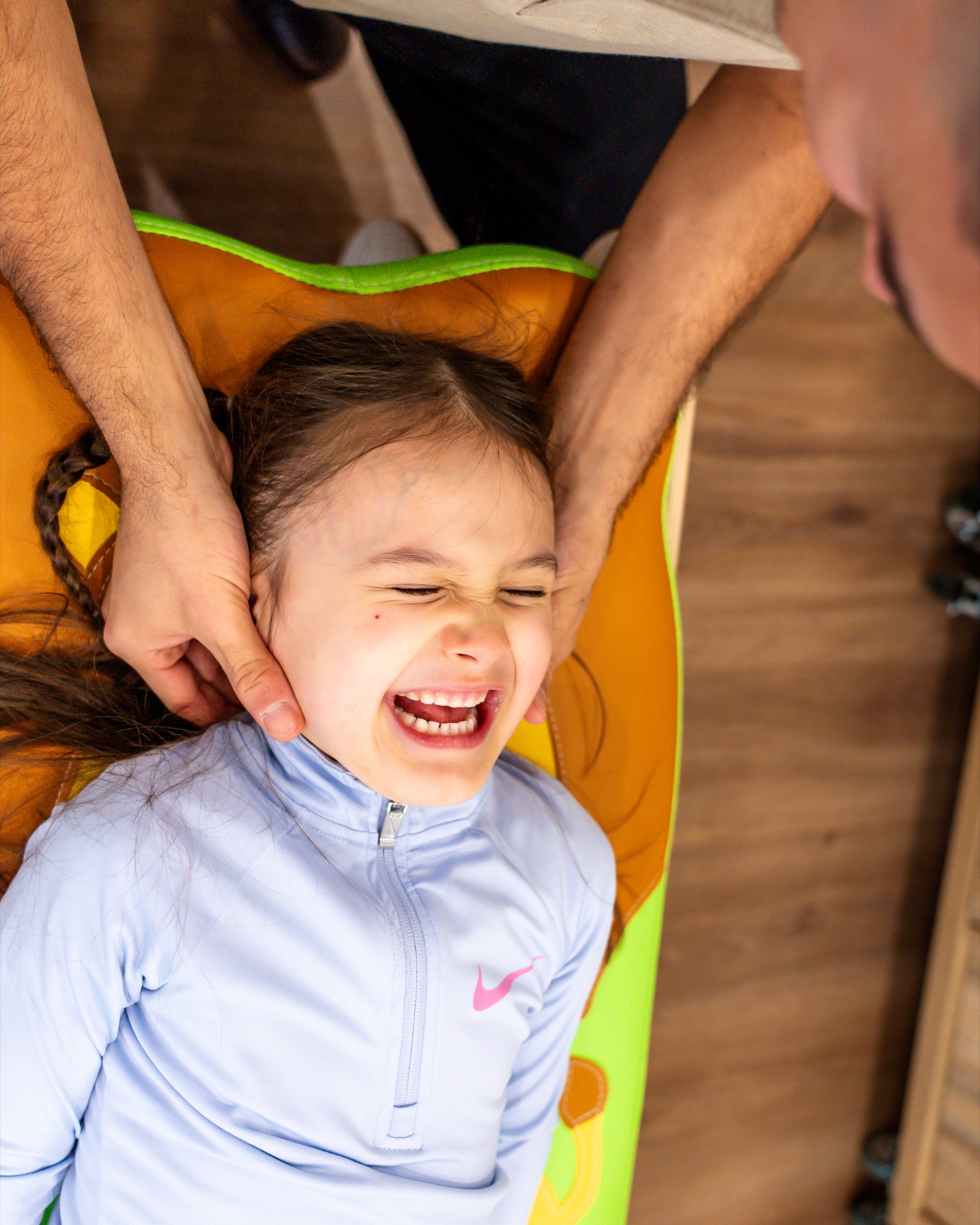Child smiling during gentle paediatric chiropractic care at Alma Health
