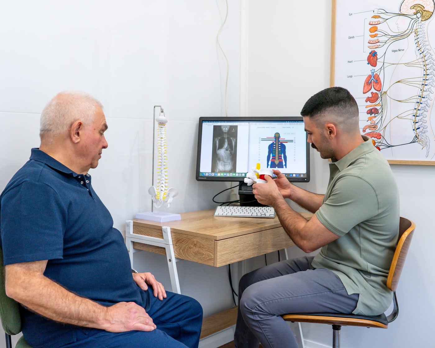 Alma Health chiropractor explaining spinal findings to a patient